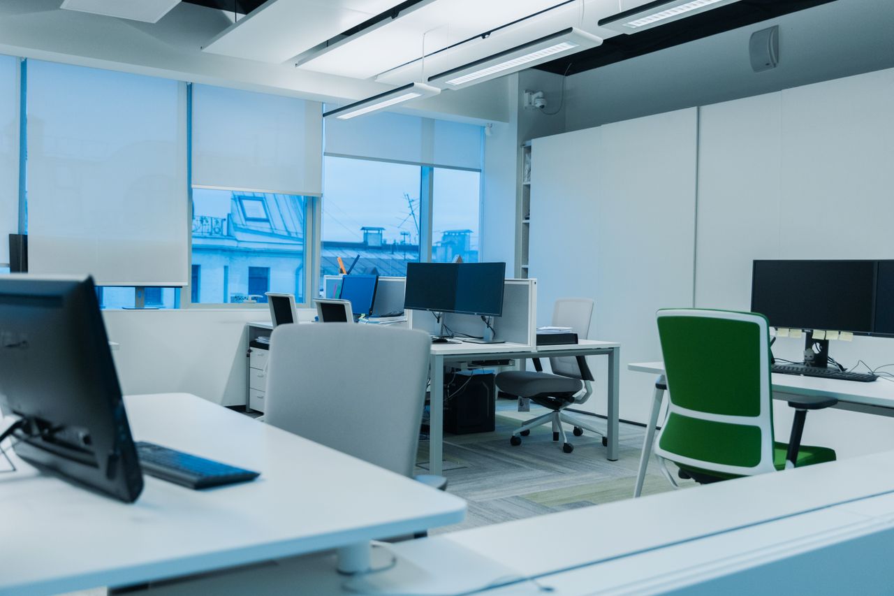 Crafting Captivating Headlines: Your awesome post title goes here Bright and modern office environment with computer workstations and large windows.